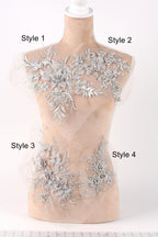 A mannequin with various decorative lace and floral embellishments on its bust area, each labeled with a different style number.