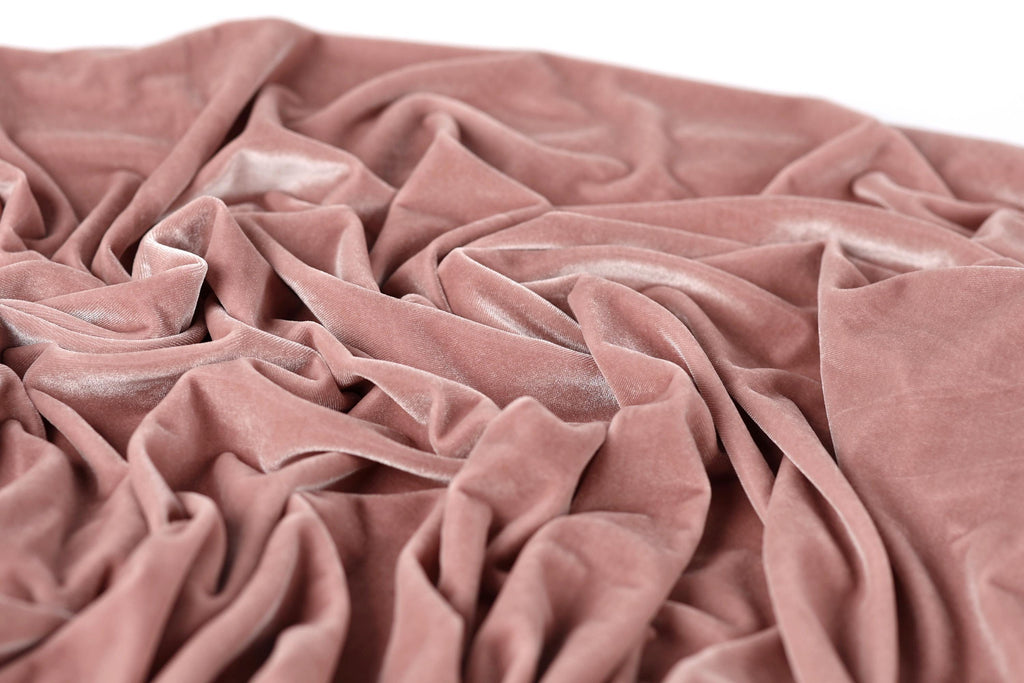 a close-up view of a crumpled, pink velvet fabric.