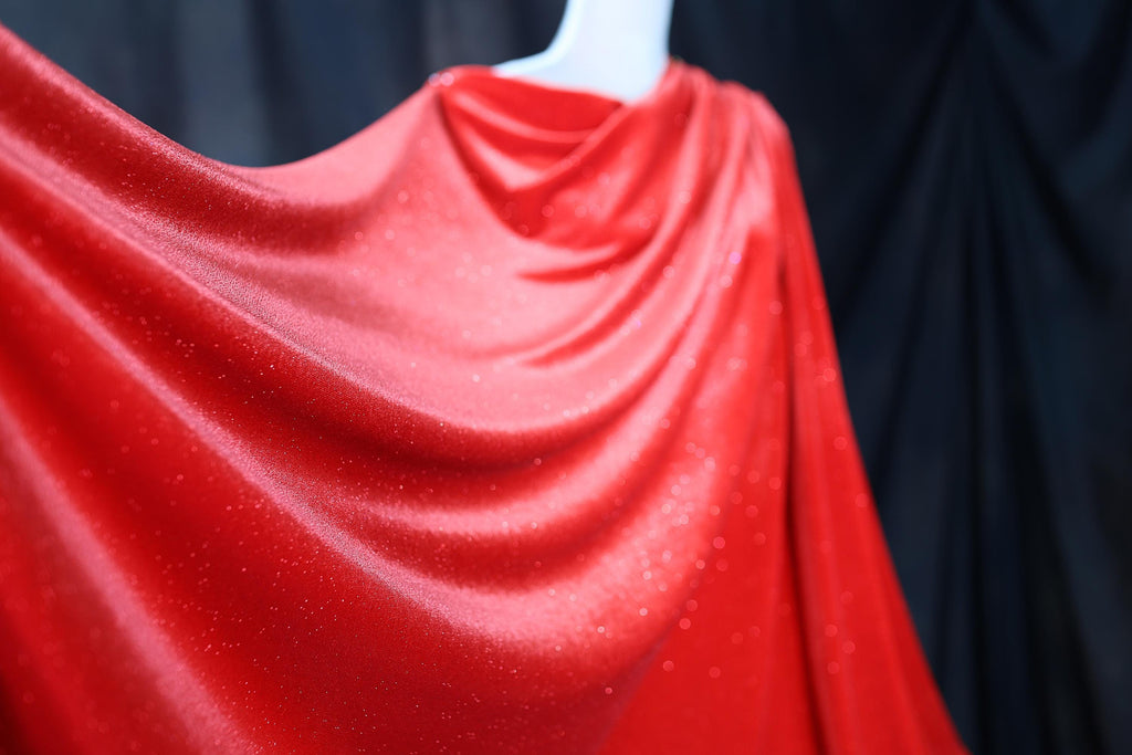 a mannequin dressed in a red cape