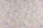 a repeating pattern of white and green flowers with glittering details, creating a visually striking and intricate design.