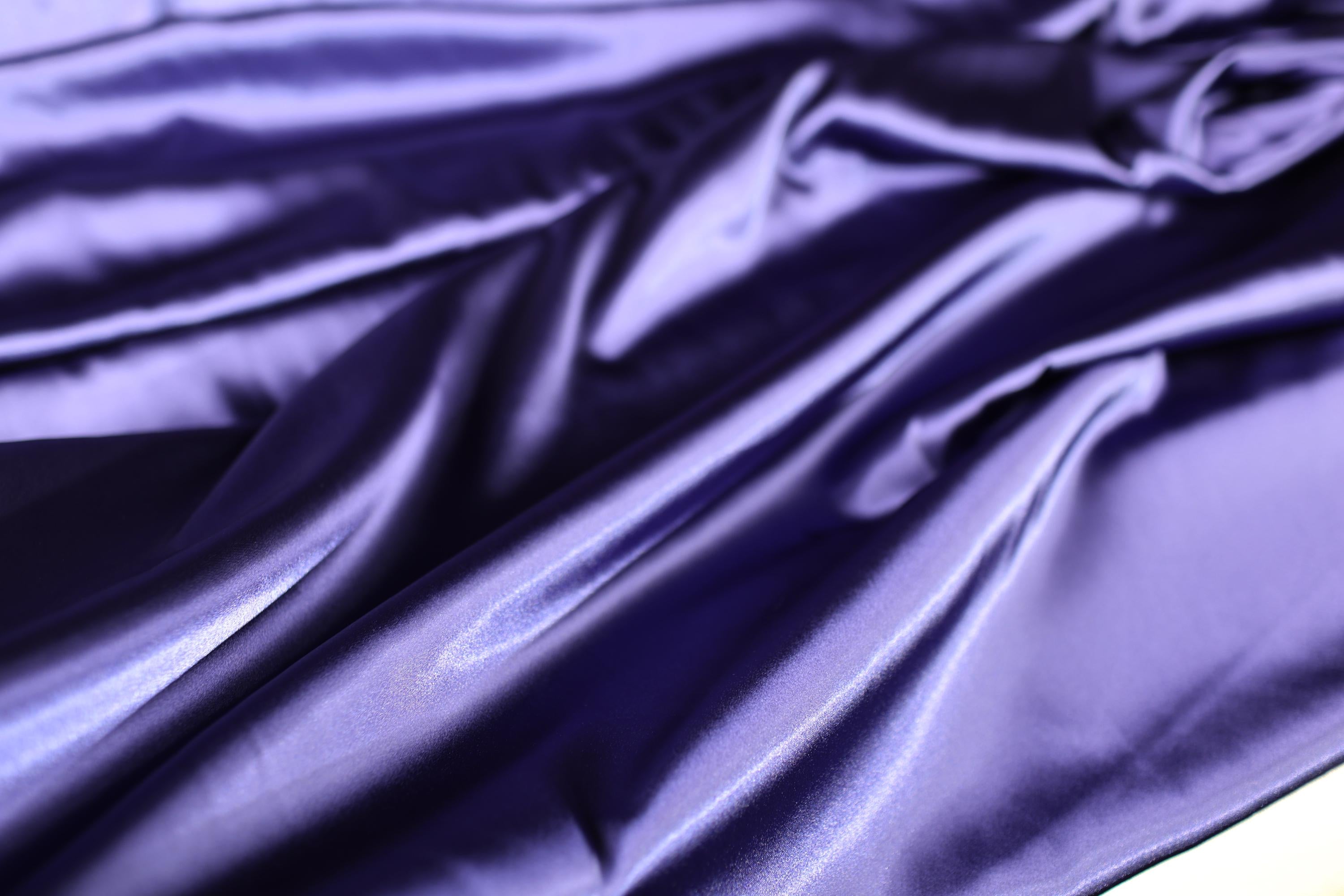 a close up of a purple satin material