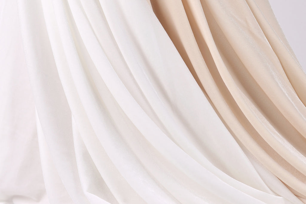 a close-up view of a fabric with a mix of white and beige colors, creating a visually appealing and textured appearance.