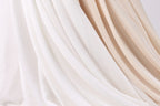 a close-up view of a fabric with a mix of white and beige colors, creating a visually appealing and textured appearance.