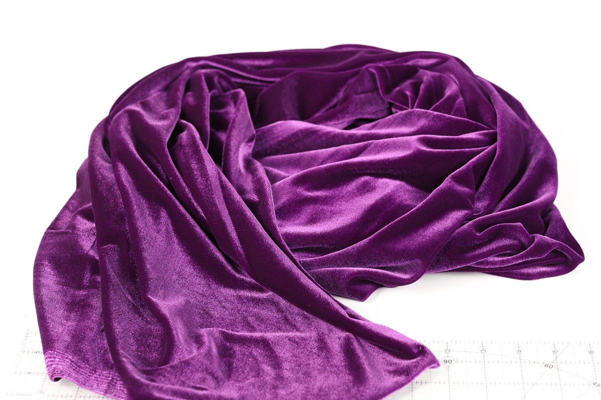 a close-up view of a purple velvet fabric, with its folds and creases visible.