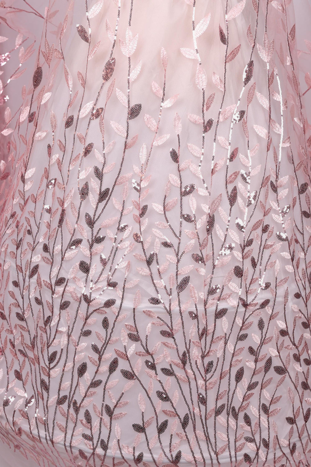a close-up view of a fabric with a delicate, leaf-like pattern in shades of pink and brown. The fabric appears to be made of sheer material, with a subtle shimmering effect due to the sequins or glitter embedded in the design. The pattern is intricate and detailed, creating a visually appealing and textured appearance.