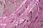 a close-up view of a fabric with a pink and purple sequin pattern. The fabric appears to be made of sheer material, with a delicate and intricate design.