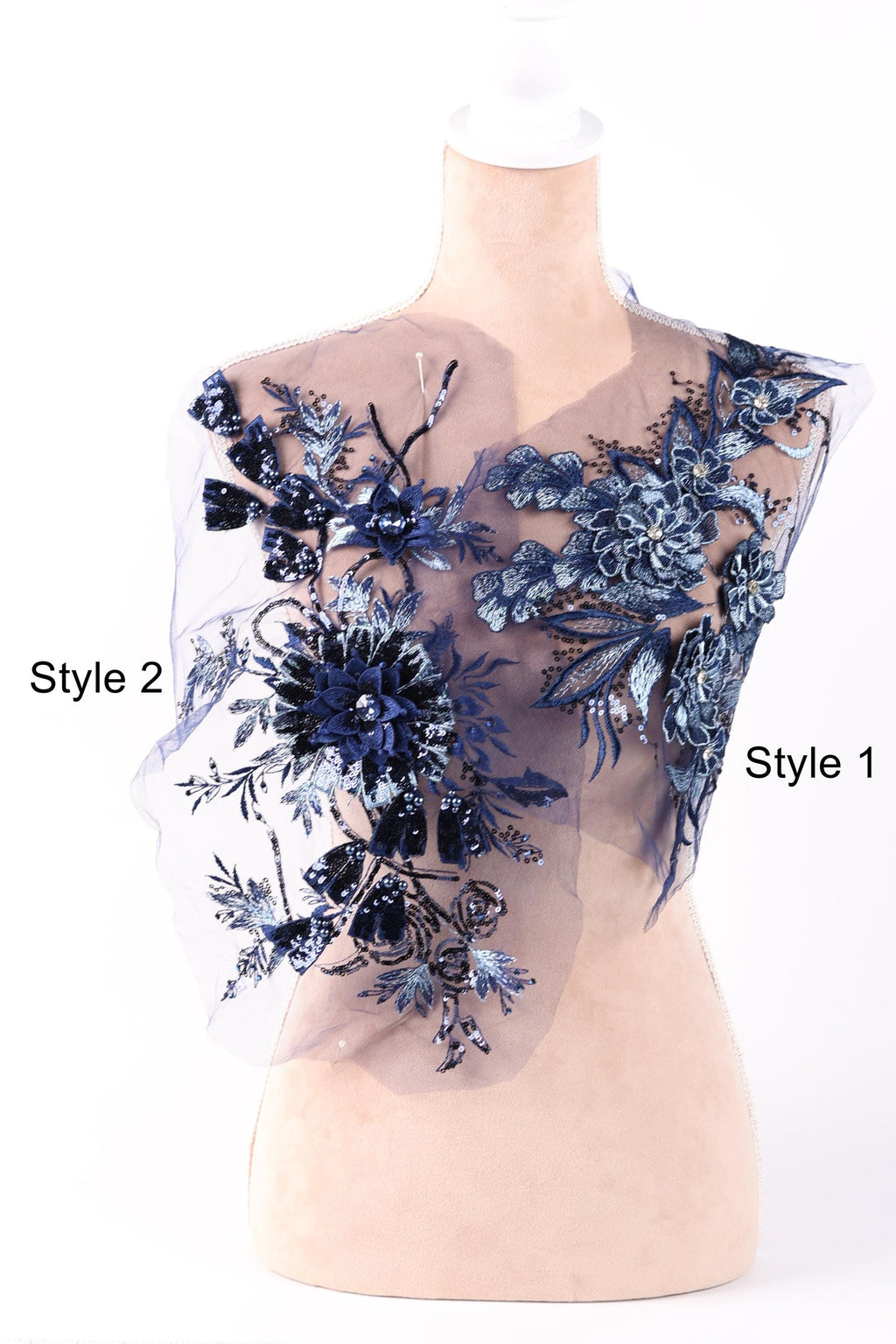 A mannequin wearing a dress with a floral pattern in shades of blue and black.