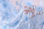 A close-up view of a delicate, intricately embroidered fabric with a floral pattern in shades of blue and white.