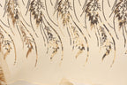 a close-up view of a fabric with a repeating pattern of gold and black sequin designs. The pattern consists of various shapes and lines, creating a visually striking and intricate design.