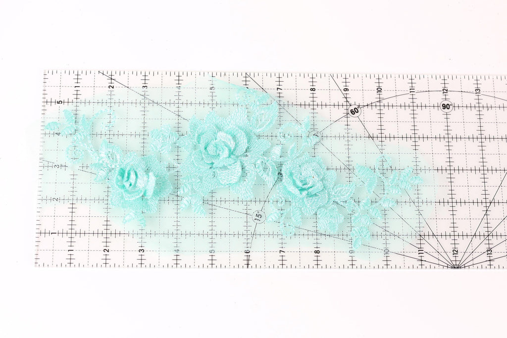 a transparent ruler with a floral pattern of light blue flowers on it.