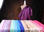 a mannequin is standing next to a row of different colored sheets