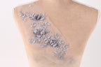 a mannequin torso with a delicate, intricate floral embroidery on the skin.