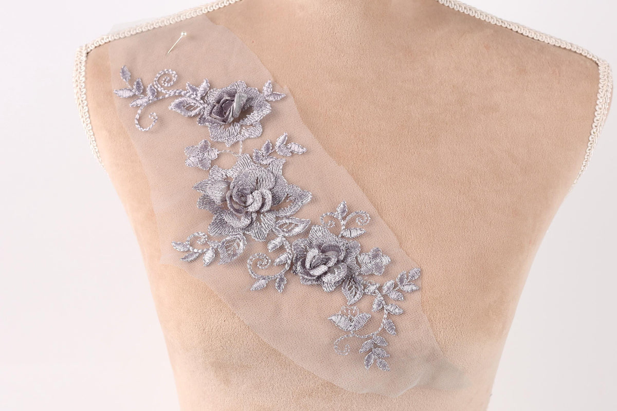 a mannequin torso with a delicate, intricate floral embroidery on the skin.