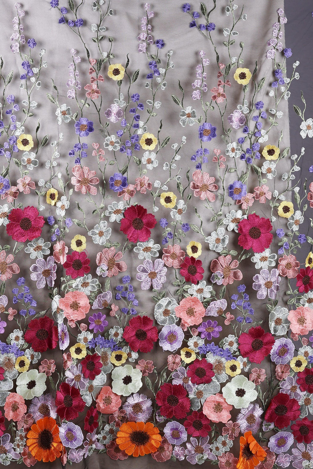 a vibrant and colorful floral pattern, with a variety of flowers in shades of pink, purple, yellow, and orange. The flowers are arranged in a repeating pattern, creating a visually striking and intricate design.