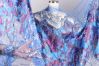 A mannequin wearing a blue and purple sequined dress with a sheer blue overlay.