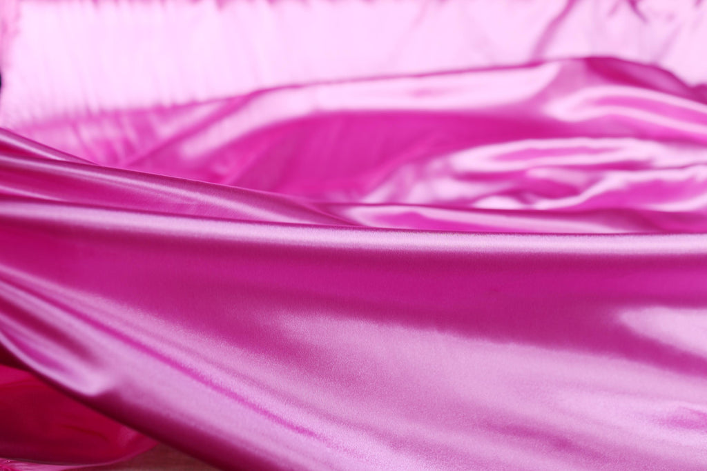 a close up of a pink satin material