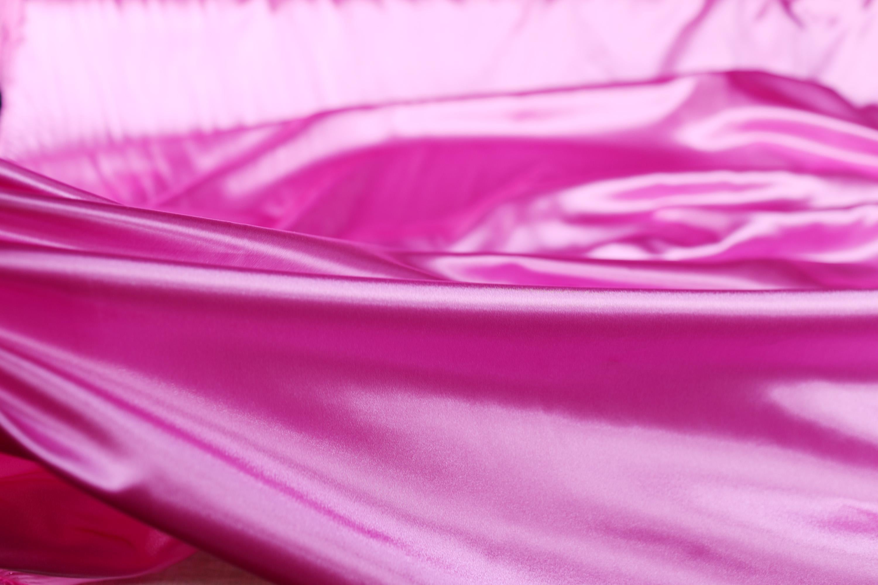 a close up of a pink satin material