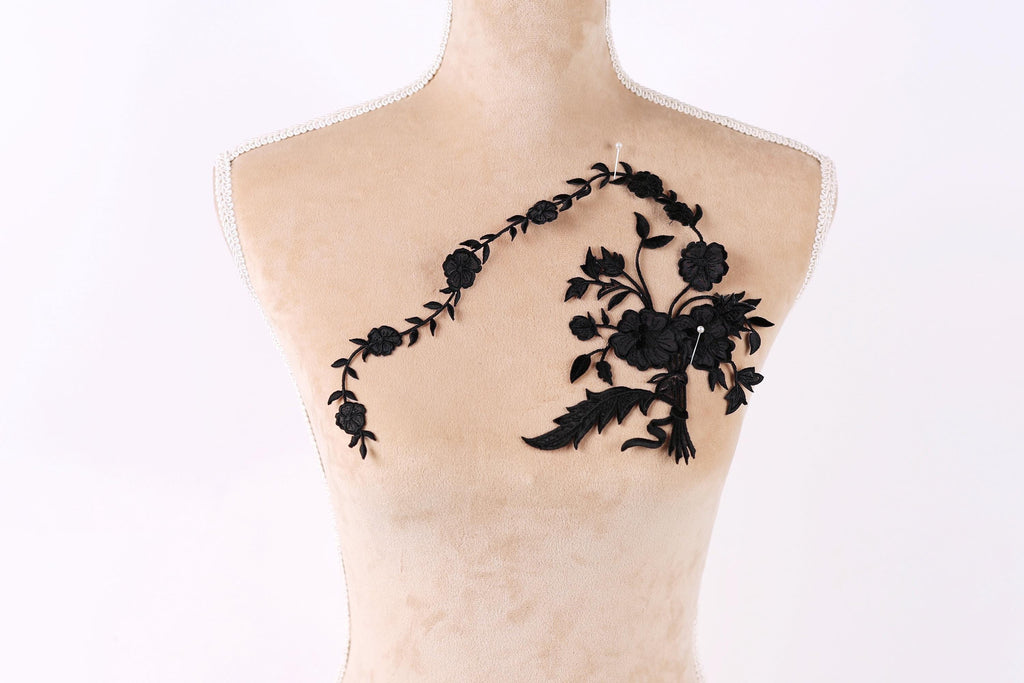A mannequin with a floral embroidered patch on its shoulder.