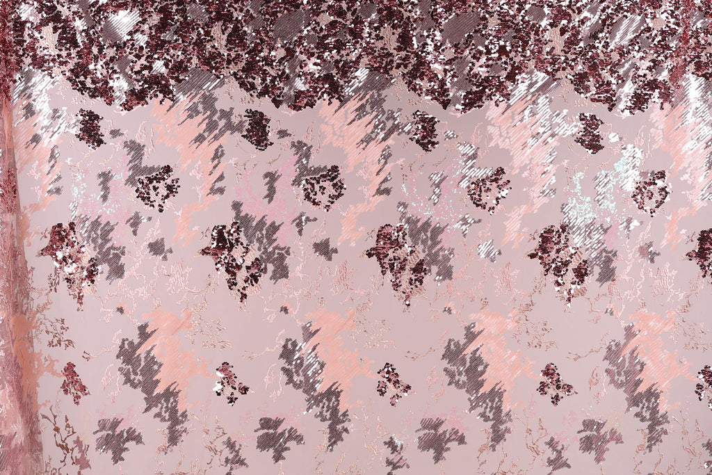The image is a collage of various pink and purple sequin patterns, creating a visually striking and textured background.