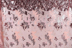The image is a collage of various pink and purple sequin patterns, creating a visually striking and textured background.