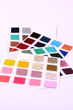a collection of fabric swatches in various colors, including pink, blue, green, and yellow, arranged on a white background.