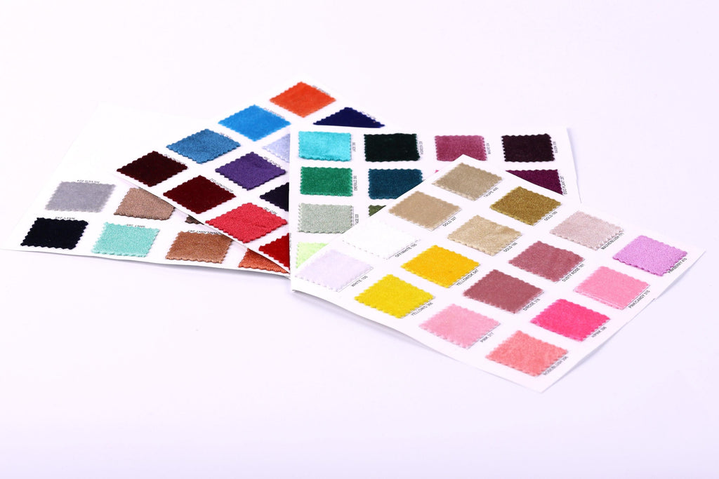 a collection of fabric swatches in various colors, including red, blue, green, and pink, arranged on a white background.