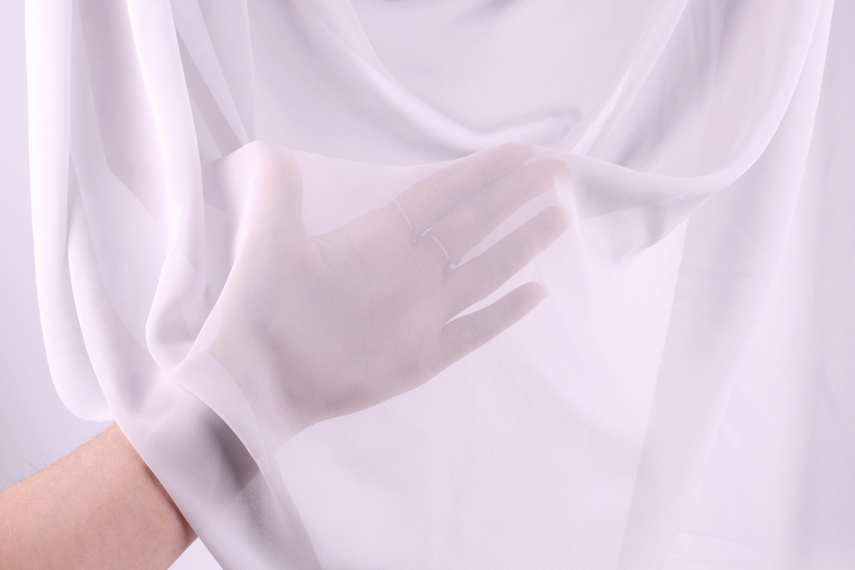 A hand wearing a white glove is partially visible, with the glove partially covering the hand and the hand partially covering the glove.