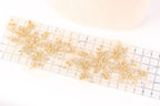 a clear ruler with a decorative gold floral pattern on it.