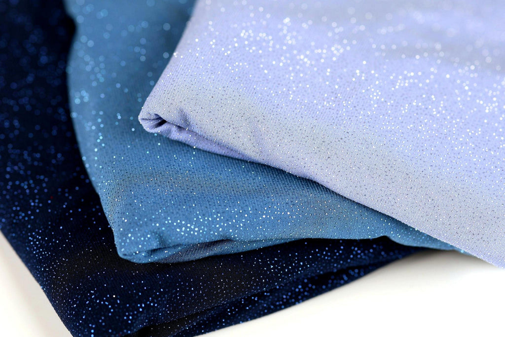 three fabric pieces with a glittery texture, stacked on top of each other.