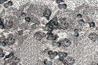 The image is a close-up of a fabric with a floral pattern, featuring a variety of blue and gray colors and intricate designs.