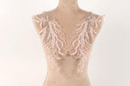 A mannequin with delicate, intricate lace or beaded embellishments on its shoulders, creating a visually appealing and elegant appearance.