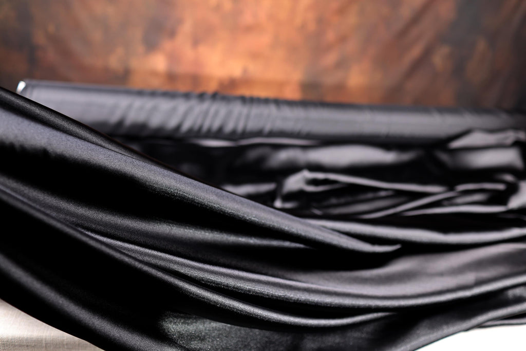 a black umbrella laying on top of a wooden table