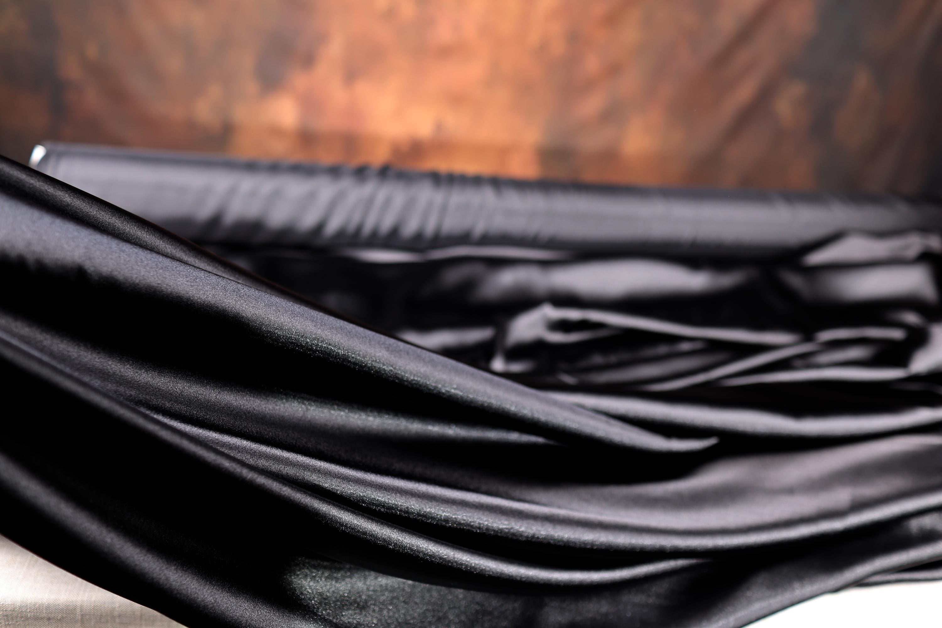 a black umbrella laying on top of a wooden table