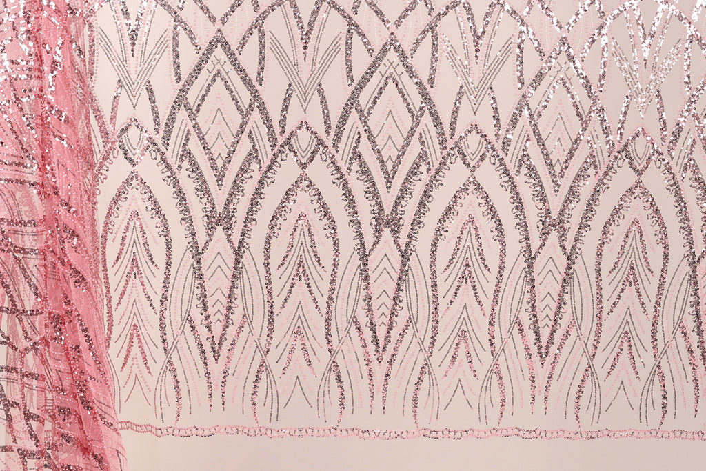 a close-up view of a fabric with a repeating pattern of pink and black lines and shapes, creating a visually striking and intricate design.