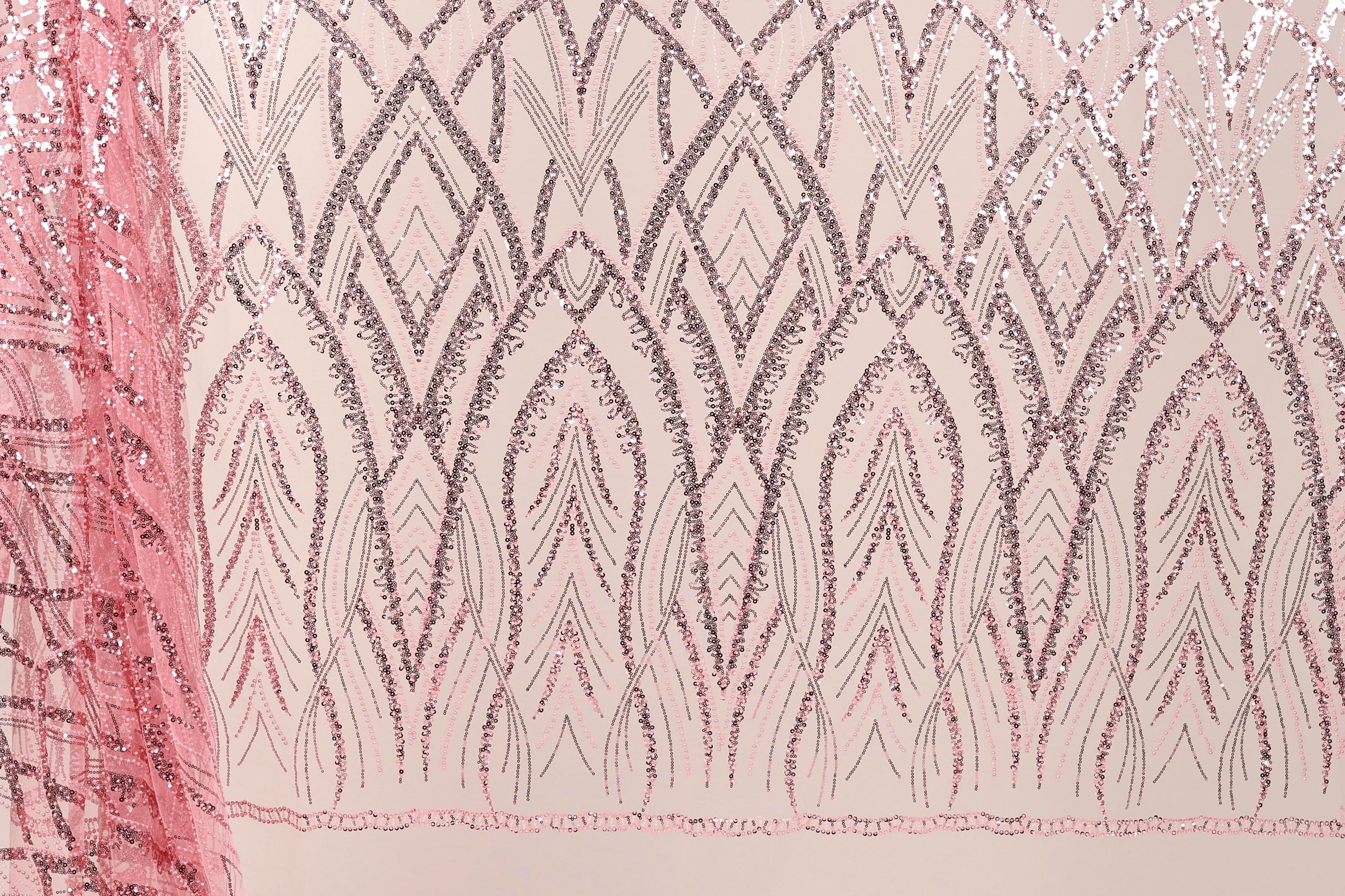 a close-up view of a fabric with a repeating pattern of pink and black lines and shapes, creating a visually striking and intricate design.