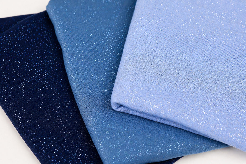three fabric swatches, each with a different color and texture, arranged in a triangular formation.