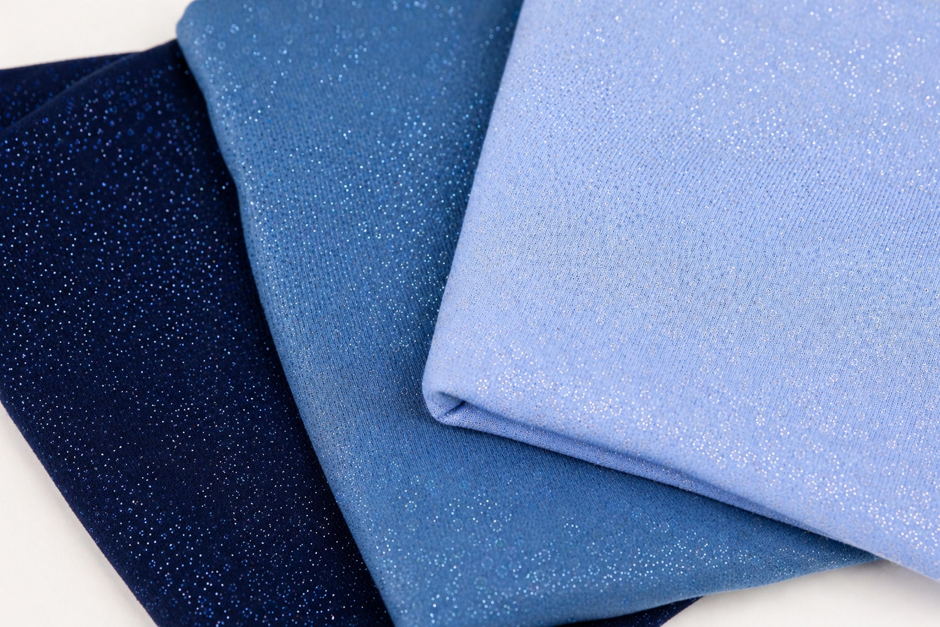 three fabric swatches, each with a different color and texture, arranged in a triangular formation.