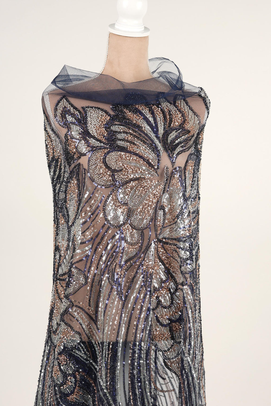 A mannequin wearing a dress with a floral pattern and sequin details.