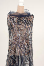 A mannequin wearing a dress with a floral pattern and sequin details.