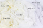 The image is a close-up of a pile of white fabric, with each fabric type labeled.