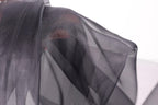 a close-up view of a black, sheer fabric, possibly silk or chiffon, with a textured and wrinkled appearance.