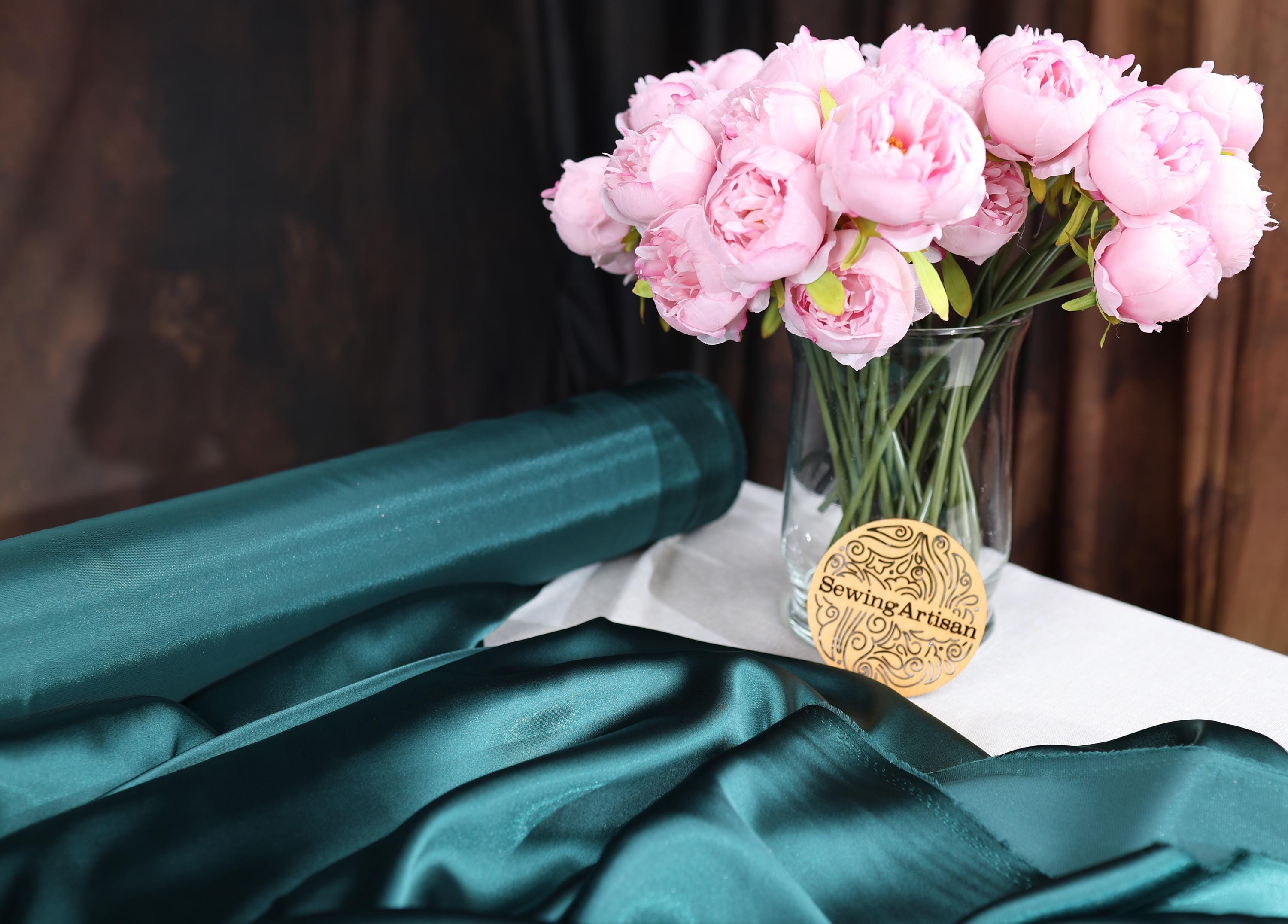 a vase filled with pink flowers on top of a table