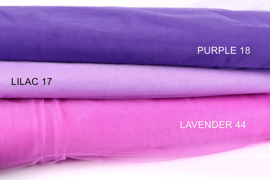 three fabric swatches, each with a different color: purple, lavender, and a shade of purple called lilac. The swatches are arranged in a stack, with the purple fabric on top and the lavender fabric below.