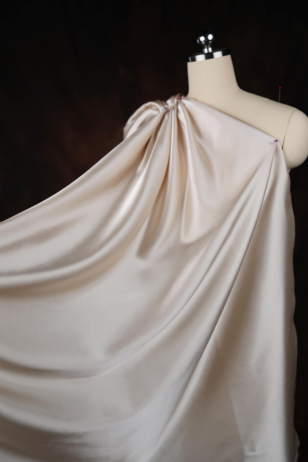 a mannequin with a white dress draped over it