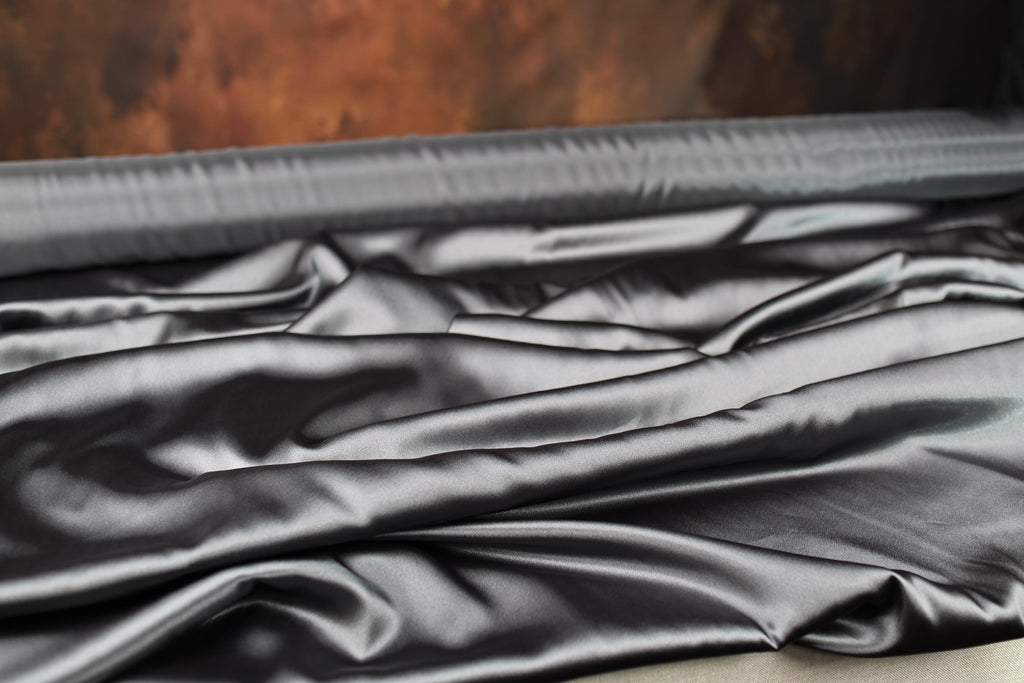 an open suitcase with a black cloth inside of it