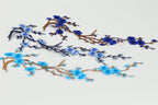 a close-up view of blue and brown branches with blue flowers, creating a visually appealing and intricate design.