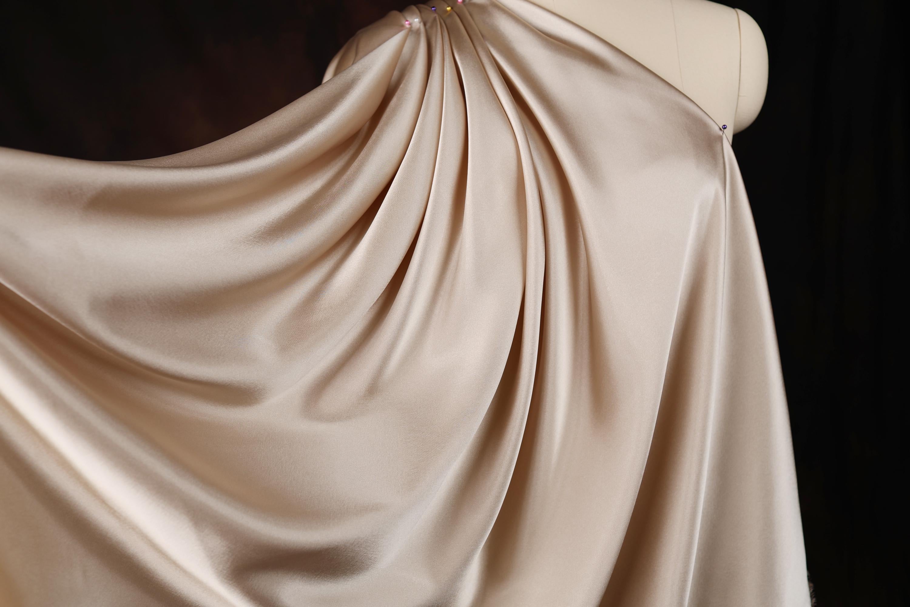 a dress on a mannequin on a black background