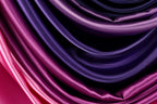 a close-up view of a fabric with a gradient of purple and pink colors, creating a visually striking and vibrant pattern.