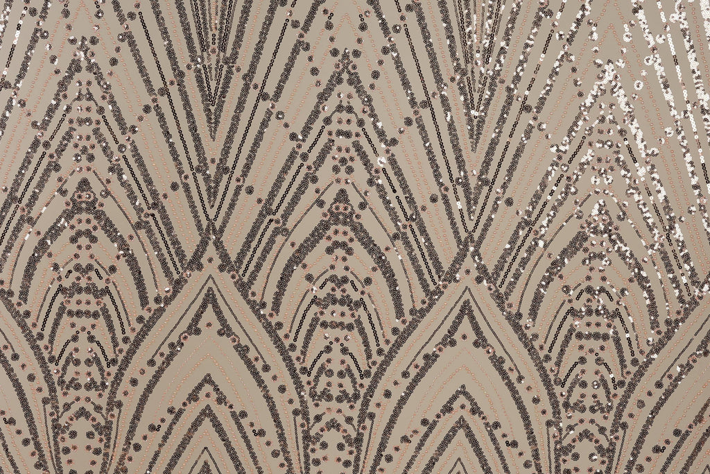 a close-up view of a patterned fabric with a repeating geometric design. The design consists of a series of arched shapes and lines, interspersed with small circular dots. The overall color scheme of the pattern is a mix of brown and beige, with some areas of black and white. The pattern appears to be a decorative textile or fabric, possibly used for clothing or home decor.