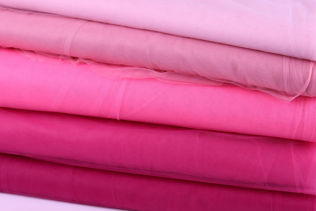 A stack of pink fabric swatches, with each swatch appearing to be a different shade of pink.